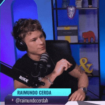 a man wearing headphones and a rode microphone talks into it