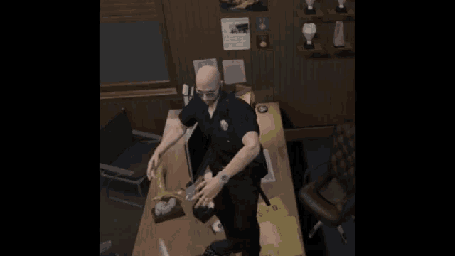 a man in a police uniform is standing in front of a desk with a newspaper on the wall