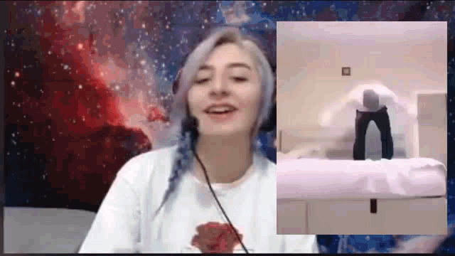 a woman wearing headphones looks at a picture of a man standing on a bed