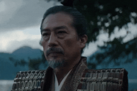 a man with a beard is wearing a samurai costume and armor .