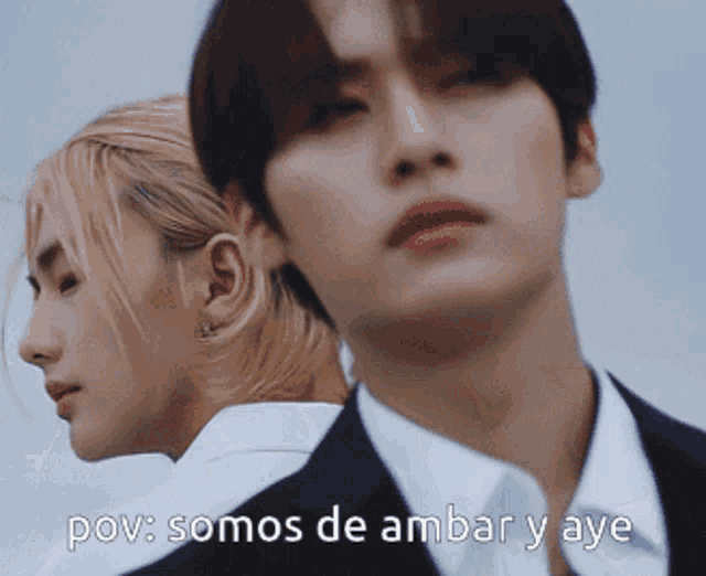 a man and a woman are standing next to each other with the words pov somos de ambar y aye written below them