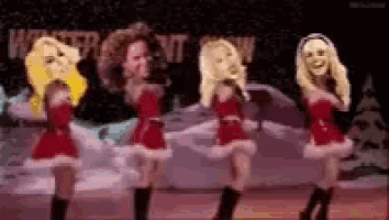 a group of women in santa costumes are dancing on a stage in front of a sign that says winter out snow .