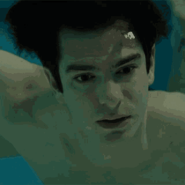 a close up of a man swimming under water
