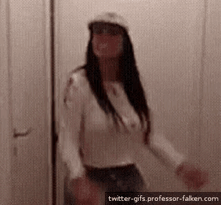 a woman is standing in a doorway wearing a hat and sunglasses .