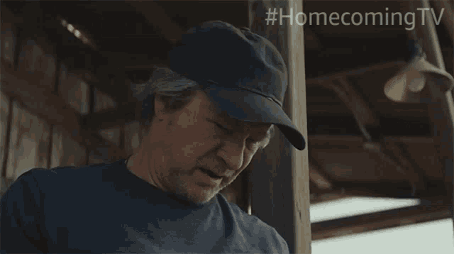 a man wearing a hat with the hashtag #homecoming tv on the bottom