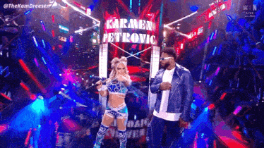 a man and a woman are standing on a stage .