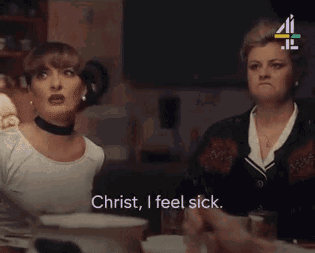 two women are sitting at a table and one of them says christ i feel sick .