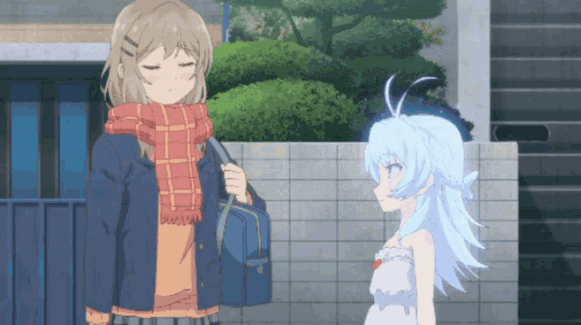 a girl with a scarf around her neck stands next to a girl with blue hair