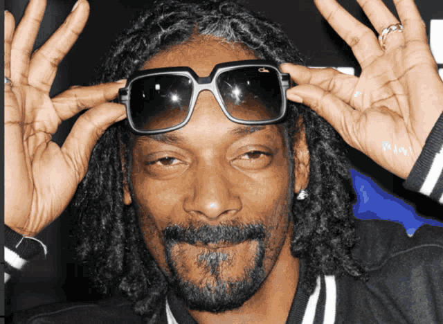snoop dogg wearing a pair of sunglasses with the letter c on it