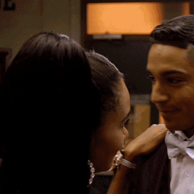 a man and a woman are looking at each other