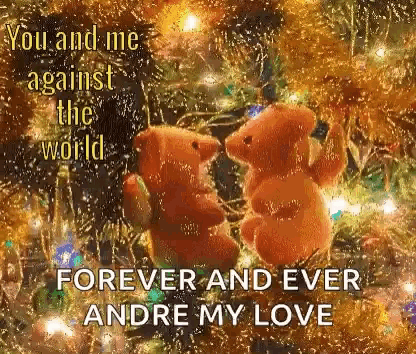 two teddy bears are sitting on top of a christmas tree .