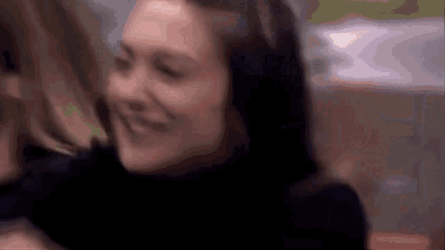 a close up of a woman 's face with a blurry background .