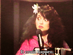 a woman singing into a microphone with the words it could happen