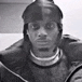a black and white photo of a man in a helmet .