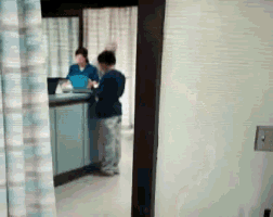 a blurred image of a man standing in front of a counter