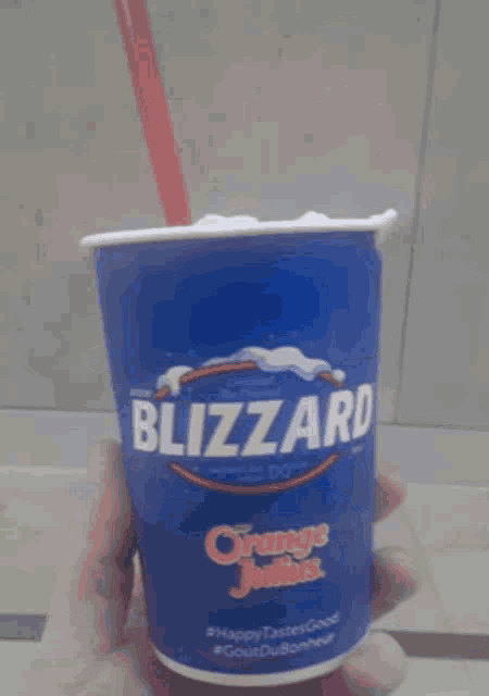 a person is holding a blue cup with the word oreo on it