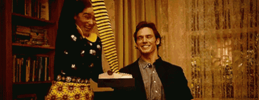 a man and woman are standing next to each other in a living room .