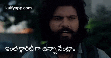 a man with a beard is talking in a foreign language and has a foreign language on his face .