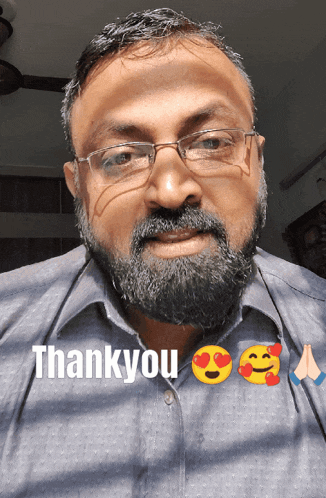 a man with a beard wearing glasses and a shirt that says thankyou