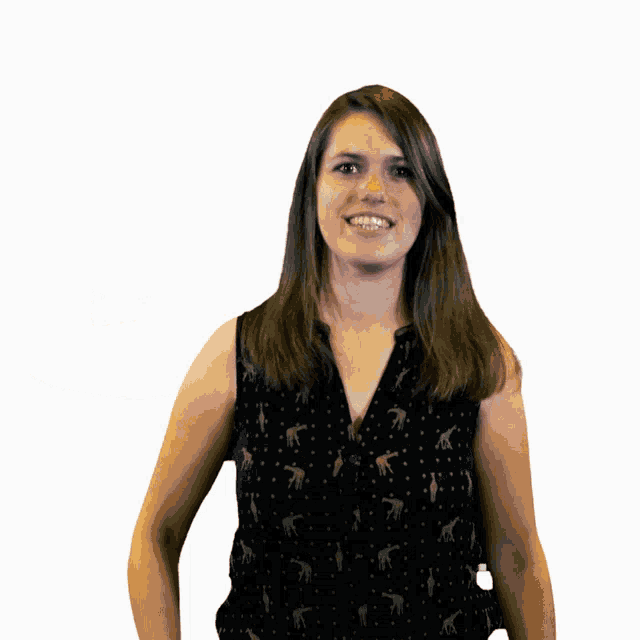 a woman wearing a black tank top with giraffes on it is smiling