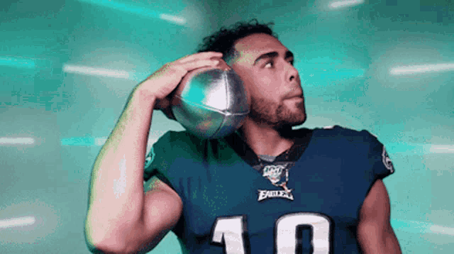 a football player with the number 10 on his jersey is throwing a ball