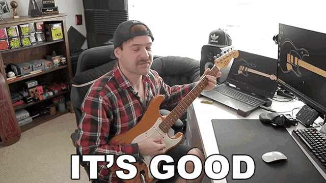 a man playing a guitar with the words " it 's good " below him