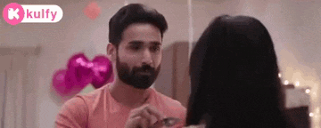 a man with a beard is looking at a woman .