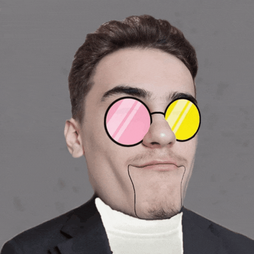 a man wearing a white turtleneck and pink and yellow glasses looks like a cartoon character