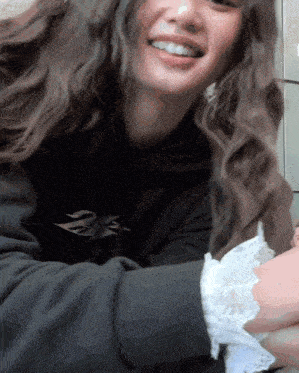 a woman wearing a black hoodie with the letter n on it