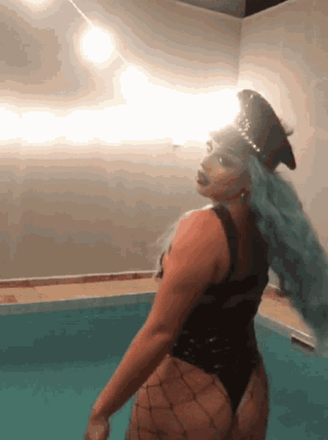 a woman in a police hat is standing in a pool