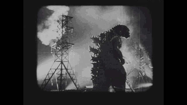 a black and white image of a monster standing in front of a power tower