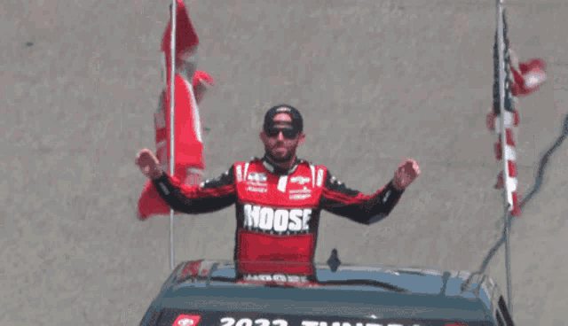 a man in a moose shirt holds a flag