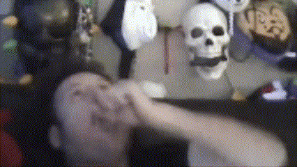 a blurry picture of a person with a skull headband behind them