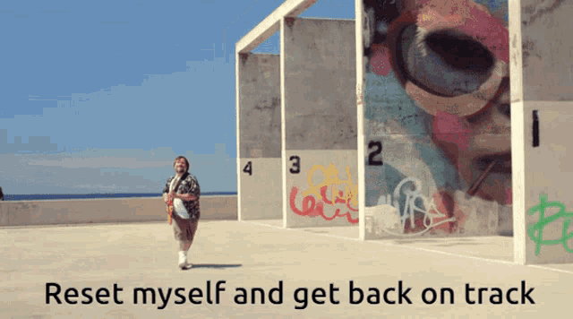 a man walking in front of a wall with the words reset myself and get back on track