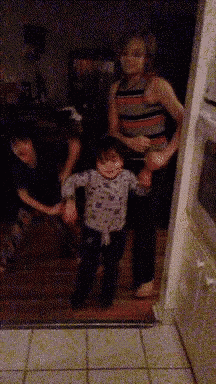 a group of people are holding hands in a dark room .