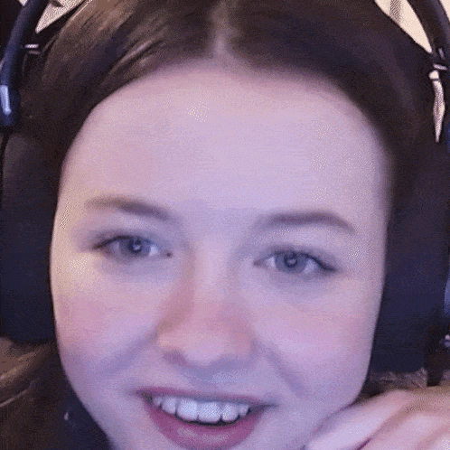 a close up of a woman 's face wearing headphones