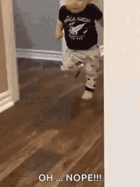 a baby is running through a doorway in a room .