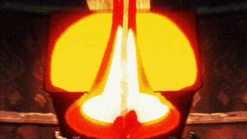 a close up of a candle being lit up in a dark room