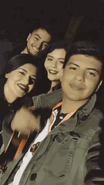 a group of people are posing for a picture with one of them holding a guitar