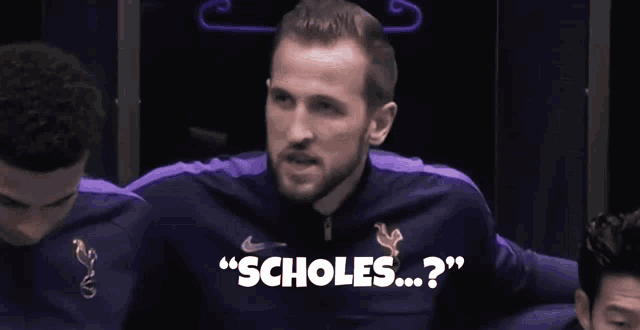 a man wearing a purple nike jacket says " scholes "