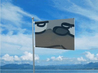 a flag with a cartoon face on it is flying in front of a blue sky