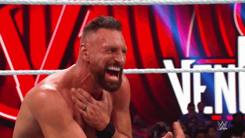 a man in a wrestling ring with a wwe logo on the bottom right