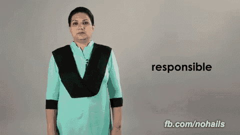 a woman in a blue shirt is making a hand gesture with the word responsible in the background