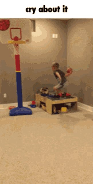 a child is playing basketball in a room with the words cry about it
