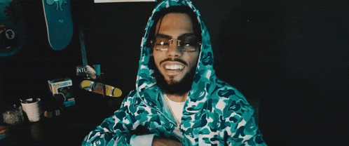 a man wearing sunglasses and a blue camo hoodie says it 's all whale talk