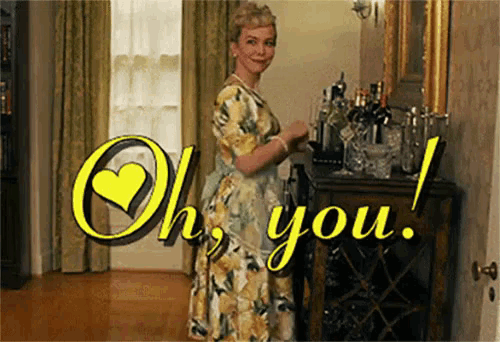 a woman in a floral dress is standing in front of a bar with the words oh you written in yellow