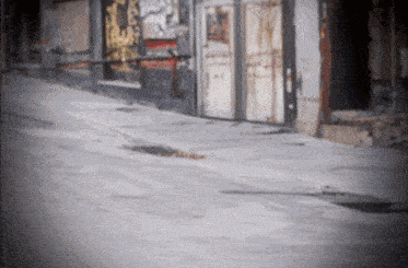 a blurred image of a street with a few buildings and a sign that says ' a ' on it