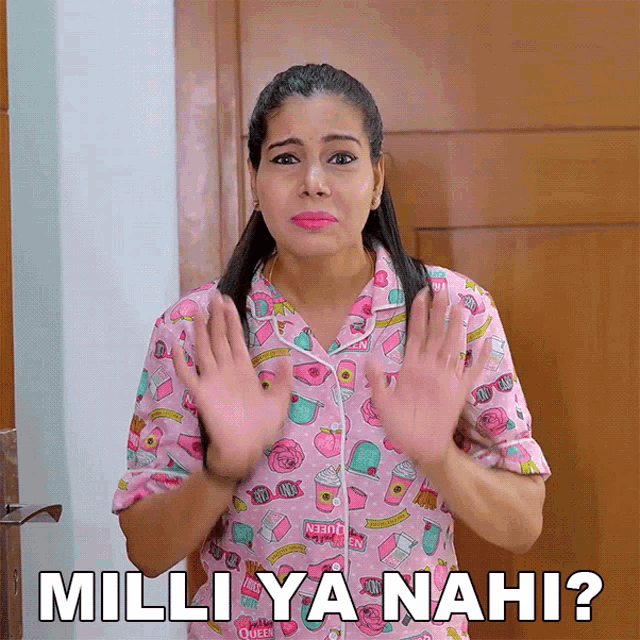 a woman wearing a pink pajama top says milliya nahi