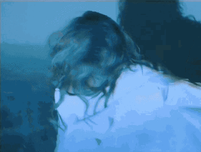 a blurry picture of a woman 's face with blue hair