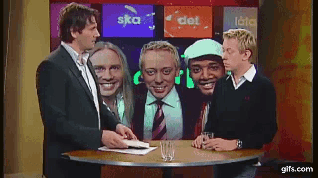 a group of men are sitting at a table in front of a screen which says ska det
